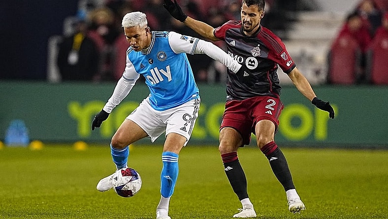 Apr 1, 2023; Toronto, Ontario, CAN; Charlotte FC forward Enzo Copetti (9) tries to control the ball against Toronto FC defender Matt Hedges (2) during the first half at BMO Field. Mandatory Credit: John E. Sokolowski-USA TODAY Sports