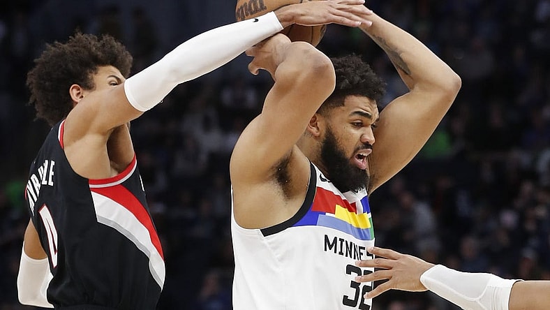 Apr 2, 2023; Minneapolis, Minnesota, USA; Portland Trail Blazers forward Matisse Thybulle (4) tries to strip the ball from Minnesota Timberwolves center Karl-Anthony Towns (32) in the third quarter at Target Center. Mandatory Credit: Bruce Kluckhohn-USA TODAY Sports