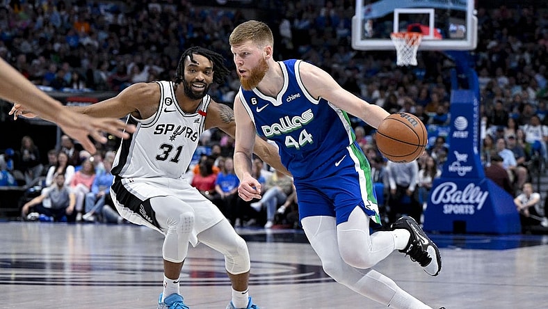 Apr 9, 2023; Dallas, Texas, USA; Dallas Mavericks forward Davis Bertans (44) drives to the basket past San Antonio Spurs forward Keita Bates-Diop (31) during the second quarter at the American Airlines Center. Mandatory Credit: Jerome Miron-USA TODAY Sports