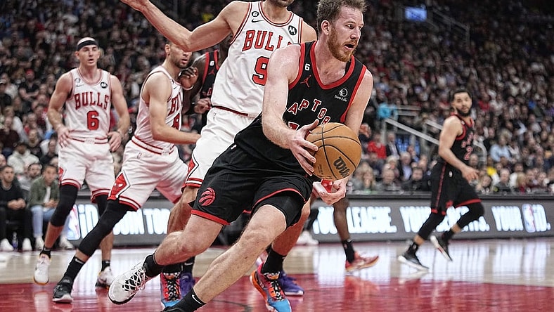 Apr 12, 2023; Toronto, Ontario, CAN; Toronto Raptors center Jakob Poeltl (19) recovers a loose ball against Chicago Bulls center Nikola Vucevic (9) during the second half of a NBA Play-In game at Scotiabank Arena. Mandatory Credit: John E. Sokolowski-USA TODAY Sports