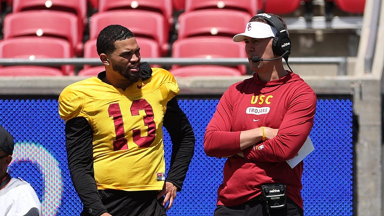 Apr 15, 2023; Los Angeles, CA, USA;  USC Trojans quarterback Caleb Williams (13) and head coach Lincoln Riley watch the game from the sideline during the Spring Game at Los Angeles Memorial Coliseum. Mandatory Credit: Kiyoshi Mio-USA TODAY Sports