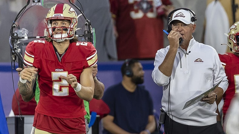 Apr 15, 2023; Birmingham, AL, USA; Birmingham Stallions quarterback Alex McGough (2) signals in the play as Birmingham Stallions head coach Skip Holtz talks on a walkie-talkie during the first half of a USFL football game against the New Jersey Generals at Protective Stadium. Mandatory Credit: Vasha Hunt-USA TODAY Sports