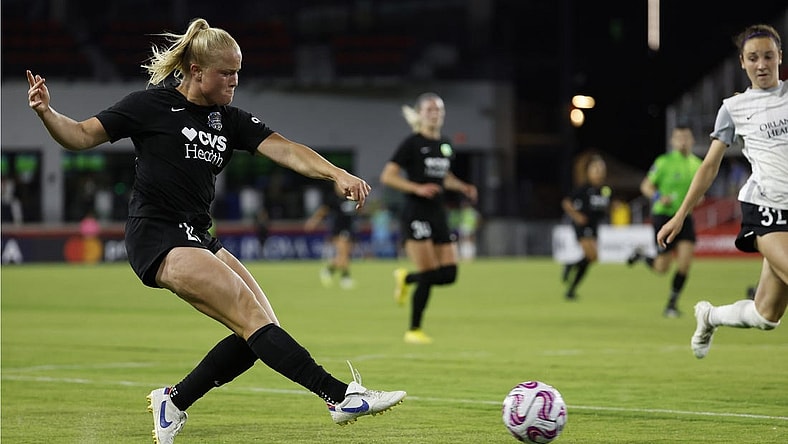 May 10, 2023; Washington, D.C., USA; Washington Spirit attacker Civana Kuhlmann (20) passes the ball as Orlando Pride defender Brianna Mart nez (32) defends in the second half of a UKG Challenge Cup match at Audi Field. Mandatory Credit: Geoff Burke-USA TODAY Sports
