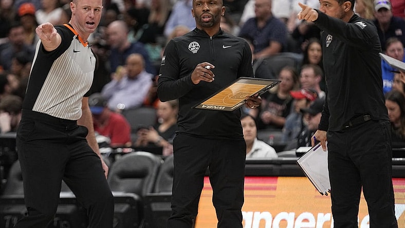 May 13, 2023; Toronto, Ontario, Canada; Chicago Sky head coach James Wade (center) listens to referee Kevin Fahy during the first half against the Minnesota Lynx at Scotiabank Arena. Mandatory Credit: John E. Sokolowski-USA TODAY Sports