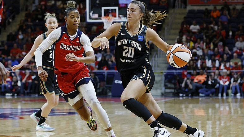 May 19, 2023; Washington, District of Columbia, USA; New York Liberty guard Sabrina Ionescu (20) drives to the basket as Washington Mystics guard Natasha Cloud (9) defends at Entertainment & Sports Arena. Mandatory Credit: Geoff Burke-USA TODAY Sports