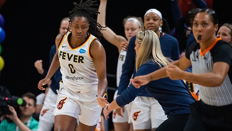 Jun 4, 2023; Indianapolis, Indiana, USA; Indiana Fever guard Kelsey Mitchell (0) celebrates a three point basket with the bench in the second half against the Las Vegas Aces at Gainbridge Fieldhouse. Mandatory Credit: Trevor Ruszkowski-USA TODAY Sports