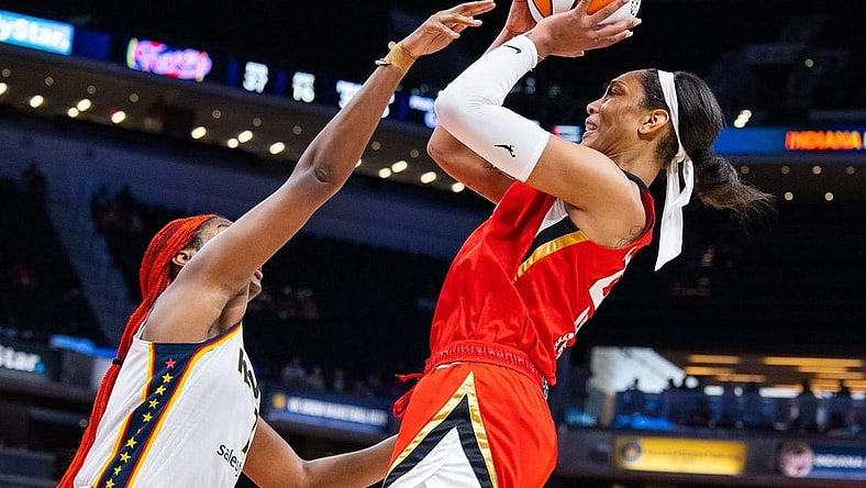 Jun 4, 2023; Indianapolis, Indiana, USA; Las Vegas Aces forward A'ja Wilson (22) shoots the ball while Indiana Fever center Aliyah Boston (7) defends in the second half at Gainbridge Fieldhouse. Mandatory Credit: Trevor Ruszkowski-USA TODAY Sports