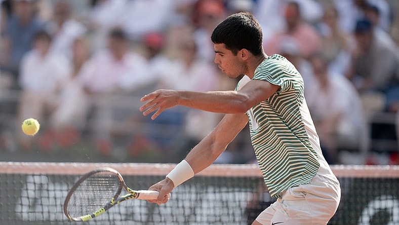 Jun 9 2023; Paris,France; Carlos Alcaraz (ESP) returns a shot during his semifinal match against Novak Djokovic (SRB) on day 13 at Stade Roland-Garros. Mandatory Credit: Susan Mullane-USA TODAY Sports