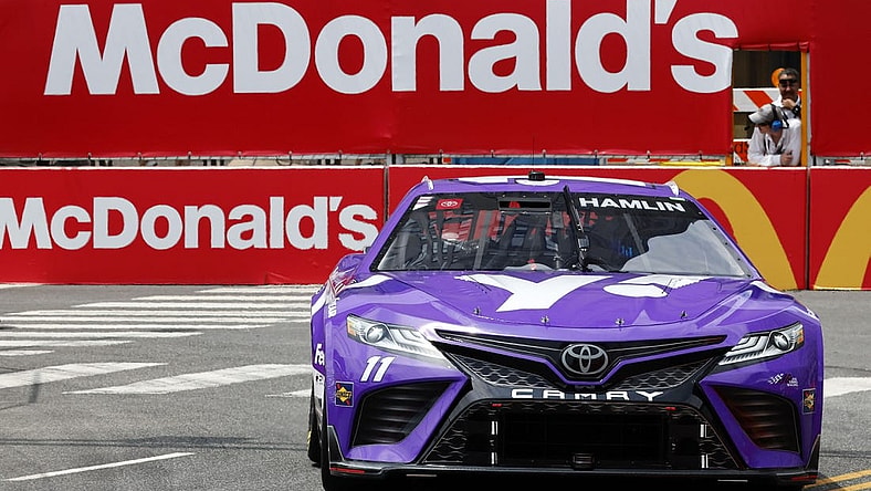 Jul 1, 2023; Chicago, Illinois, USA; NASCAR Cup Series driver Denny Hamlin (11) drives along Grant Park during practice and qualifying for the Chicago Street Race. Mandatory Credit: Mike Dinovo-USA TODAY Sports