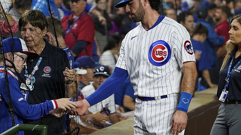Jul 1, 2023; Chicago, Illinois, USA; Chicago Cubs shortstop Dansby Swanson (7) signs an autograph before the game between the Chicago Cubs and the Cleveland Guardians at Wrigley Field. Mandatory Credit: David Banks-USA TODAY Sports