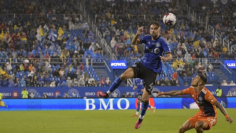 Jul 1, 2023; Montreal, Quebec, CAN; CF Montreal defender Rudy Camacho (4) heads the ball over New York City FC midfielder Santiago Rodriguez (10) in the second half at Stade Saputo. Mandatory Credit: Eric Bolte-USA TODAY Sports