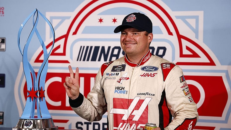 Jul 2, 2023; Chicago, Illinois, USA;  Xfinity Series driver Cole Custer (00) poses with the race trophy after the race was canceled by NASCAR due to flooding for The Loop 121 of the Chicago Street Race. Mandatory Credit: Mike Dinovo-USA TODAY Sports