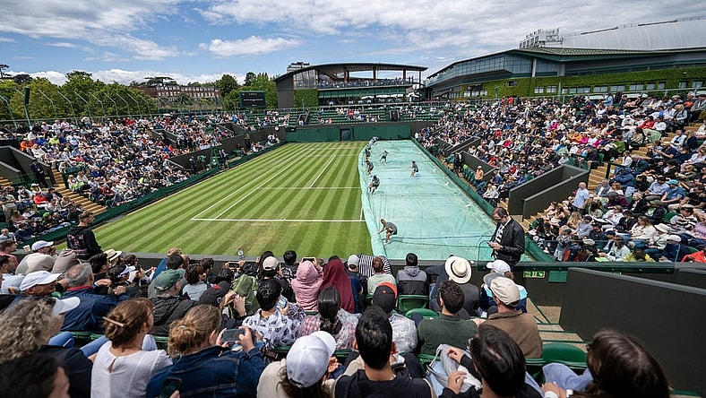 Jul 5, 2023; London, United Kingdom; The grounds staff uncover Court 3 so play will resume on day three of Wimbledon at the All England Lawn Tennis and Croquet Club.  Mandatory Credit: Susan Mullane-USA TODAY Sports