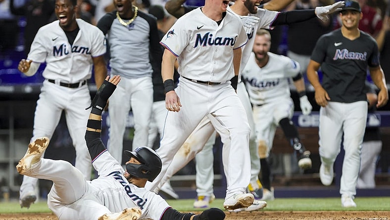 Jul 5, 2023; Miami, Florida, USA; Miami Marlins first baseman Yuli Gurriel (10) scores the winning run against the St. Louis Cardinals as Miami Marlins players celebrate during the ninth inning at loanDepot Park. Mandatory Credit: Sam Navarro-USA TODAY Sports