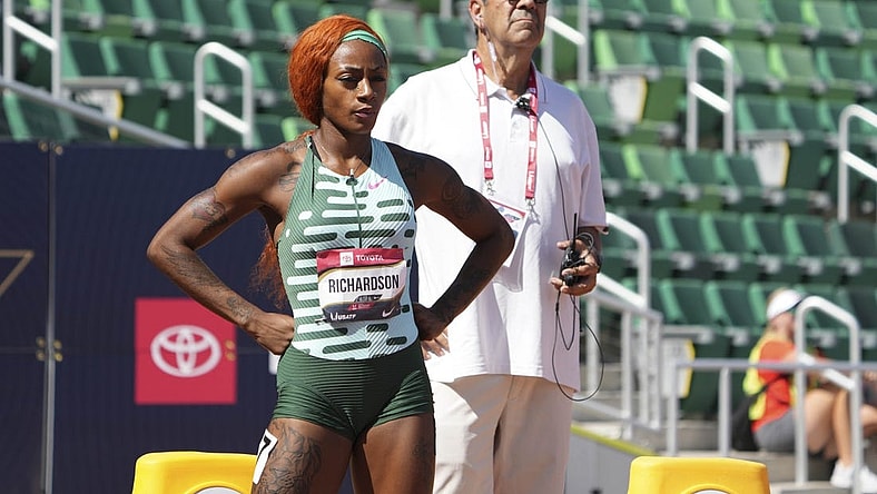 Jul 6, 2023; Eugene, OR, USA; Ventura County deputy attorney general David Glassman stands behind Sha'Carri Richardson during a women's 100m heat at the USATF Championships at Hayward Field. Mandatory Credit: Kirby Lee-USA TODAY Sports