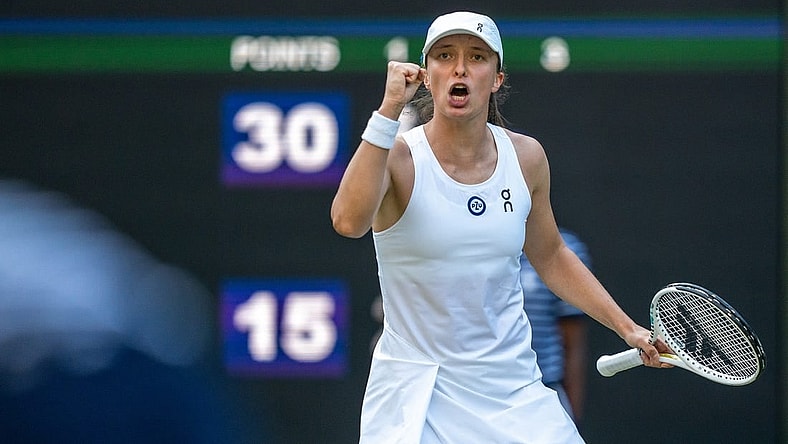 Jul 7, 2023; London, United Kingdom; Iga Swiatek (POL) reacts to a point during her match against Petra Martic (CRO) on day five of Wimbledon at the All England Lawn Tennis and Croquet Club.  Mandatory Credit: Susan Mullane-USA TODAY Sports