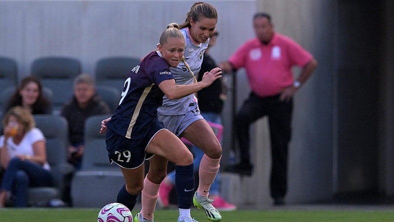 Jul 9, 2023; Los Angeles, California, USA; Angel City FC midfielder Dani Weatherholt (17) and North Carolina Courage forward Millie Farrow (29) battle for the ball during the first half at BMO Stadium. Mandatory Credit: Jayne Kamin-Oncea-USA TODAY Sports