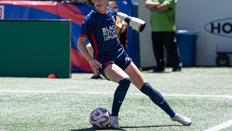 Jul 1, 2023; Seattle, Washington, USA; OL Reign defender Phoebe McClernon (21) gets control of the ball against Racing Louisville at Lumen Field. Mandatory Credit: Stephen Brashear-USA TODAY Sports