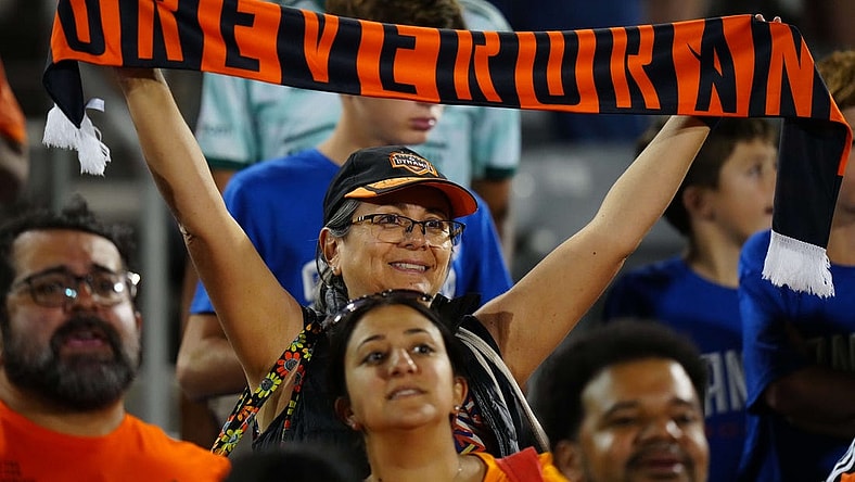 Jul 15, 2023; Commerce City, Colorado, USA; A Houston Dynamo FC fan holds up a scarf to show her support during the game between the Colorado Rapids and Houston Dynamo FC at Dick's Sporting Goods Park. Mandatory Credit: Ron Chenoy-USA TODAY Sports