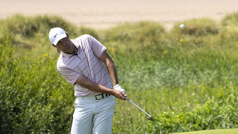 July 19, 2023; Hoylake, ENGLAND, GBR; Scottie Scheffler hits a chip shot on the 17th hole during a practice round of The Open Championship golf tournament at Royal Liverpool. Mandatory Credit: Kyle Terada-USA TODAY Sports