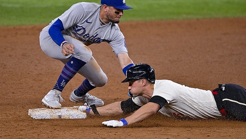 Jul 21, 2023; Arlington, Texas, USA; Texas Rangers shortstop Corey Seager (5) slides under the throw to Los Angeles Dodgers shortstop Miguel Rojas (11) at second base during the eighth inning at Globe Life Field. Mandatory Credit: Jerome Miron-USA TODAY Sports