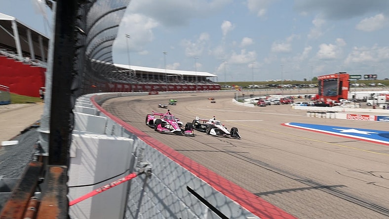 Jul 22, 2023; Newton, Iowa, USA; Team Penske driver Josef Newgarden (2) of United States and Meyer Shank Racing driver Conor Daly (60) of United States lead traffic down the front stretch during the Hy-Vee Homefront 250 at Iowa Speedway. Mandatory Credit: Reese Strickland-USA TODAY Sports