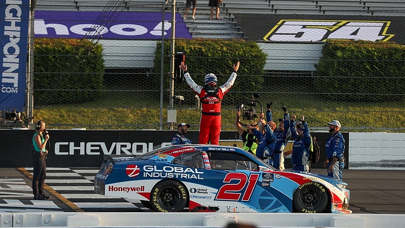 Jul 22, 2023; Long Pond, Pennsylvania, USA; NASCAR Xfinity Series driver Austin Hill (21) celebrates after winning the Explore The Pocono Mountains 225 at Pocono Raceway. Mandatory Credit: Matthew O'Haren-USA TODAY Sports