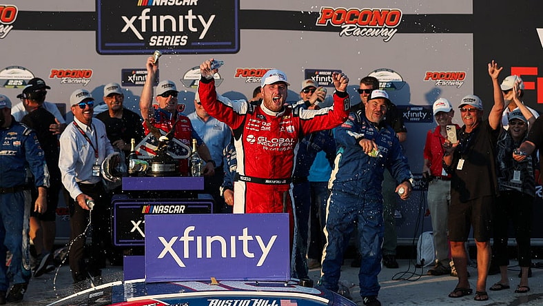 Jul 22, 2023; Long Pond, Pennsylvania, USA; NASCAR Xfinity Series driver Austin Hill celebrates in victory lane after winning the Explore The Pocono Mountains 225 at Pocono Raceway. Mandatory Credit: Matthew O'Haren-USA TODAY Sports
