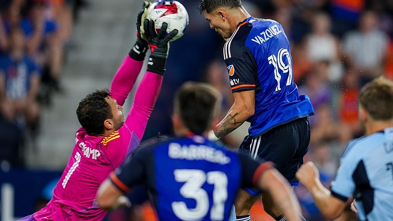 Jul 23, 2023; Cincinnati, OH, USA; Sporting Kansas City goalkeeper John Pulskamp (1) attempts a save against FC Cincinnati forward Brandon Vazquez (19) in the second half at TQL Stadium. Mandatory Credit: Aaron Doster-USA TODAY Sports