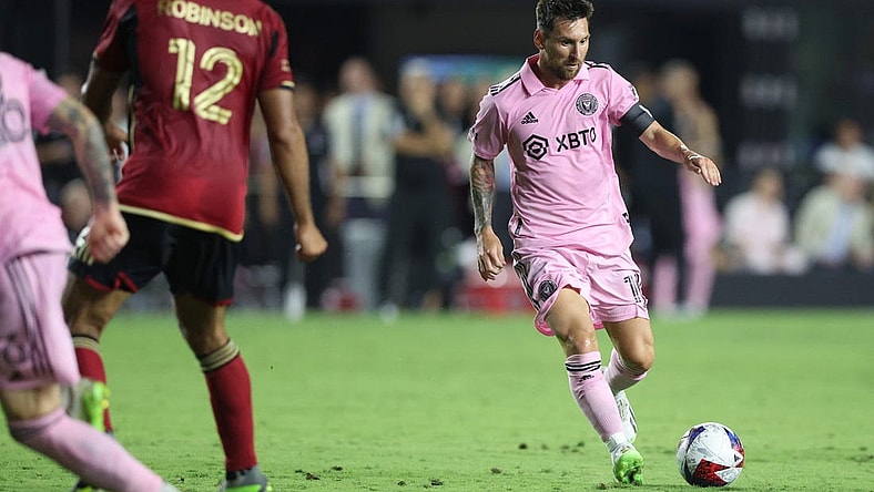 Jul 25, 2023; Fort Lauderdale, FL, USA; Inter Miami CF forward Lionel Messi (10) dribbles against Atlanta United defender Ronald Hernandez (2) during the second half at DRV PNK Stadium. Mandatory Credit: Nathan Ray Seebeck-USA TODAY Sports