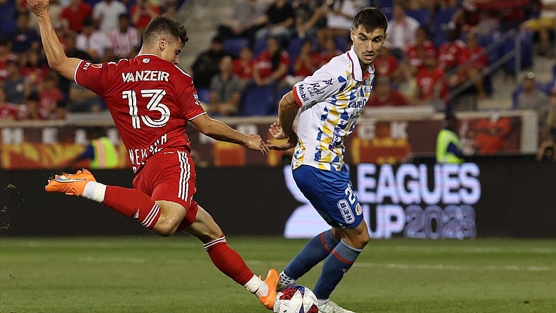 Jul 30, 2023; Harrison, NJ, USA; New York Red Bulls forward Dante Vanzeir (13) shoots the ball in front of Atletico De San Luis defender Pablo Martinez (28) during the second half at Red Bull Arena. Mandatory Credit: Vincent Carchietta-USA TODAY Sports