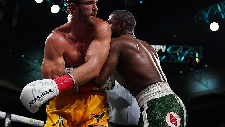 Jun 6, 2021; Miami, Florida, USA; Floyd Mayweather Jr. (Green Trunks) fights Logan Paul (Yellow Trunks) during an exhibition boxing match at Hard Rock Stadium. Mandatory Credit: Jasen Vinlove-USA TODAY Sports