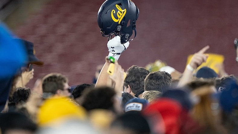 Nov 20, 2021; Stanford, California, USA; California Golden Bears helmet is raised into the air amongst fans after defeating the Stanford Cardinal at Stanford Stadium. Mandatory Credit: Stan Szeto-USA TODAY Sports