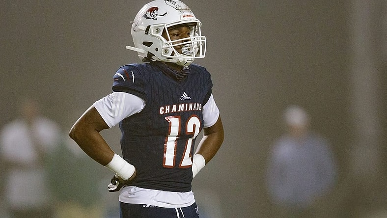 Chaminade-Madonna's Zaquan Patterson (12) walks off the field to meet with his team during a timeout. Chaminade-Madonna shutout Berkeley Prep 21-0 to claim the 3A State Championship title at Gene Cox Stadium on Friday, Dec. 10, 2021.

Second Half Chaminade Madonna V Bp 021
