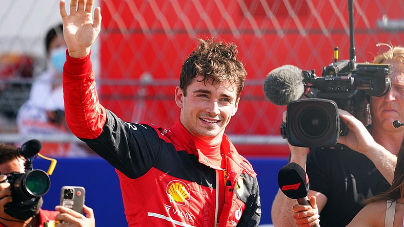 May 7, 2022; Miami Gardens, Florida, USA; Ferrari driver Charles Leclerc of Monaco waves to the fans in the stands after winning the pole position following qualifying for the Miami Grand Prix at Miami International Autodrome. Mandatory Credit: John David Mercer-USA TODAY Sports