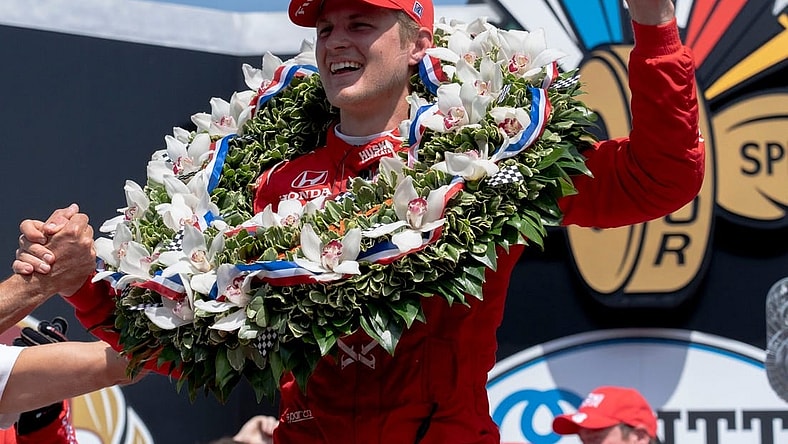 May 29, 2022; Indianapolis, IN, USA;  Chip Ganassi Racing driver Marcus Ericsson (8) celebrates on the podium with the milk after winning the 106th running of the Indianapolis 500 at Indianapolis Motor Speedway. Mandatory Credit: Mykal McEldowney-USA TODAY Sports