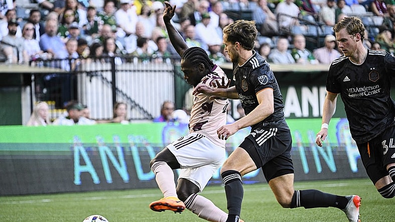 Jun 29, 2022; Portland, Oregon, USA; Houston Dynamo defender Adam Lundqvist (3) defends Portland Timbers forward Yimmi Chara (23) during the first half at Providence Park. The Timbers won 2-1. Mandatory Credit: Troy Wayrynen-USA TODAY Sports