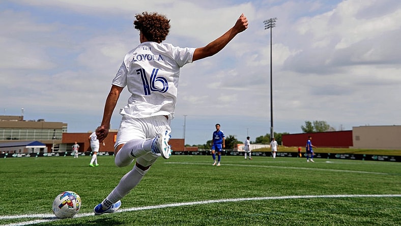 Aug 10, 2022; Blaine, MN, USA; MLS Next East player Favian Loyola (16) of Orlando City takes a corner kick against MLS Next West during the second half of the 2022 MLS NEXT All-Star Game at National Sports Center Indoor Sports Hall. Mandatory Credit: Kirby Lee-USA TODAY Sports