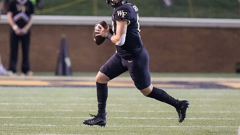 Sep 1, 2022; Winston-Salem, North Carolina, USA; Wake Forest Demon Deacons quarterback Mitch Griffis (12) scrambles out of the pocket to pass against the Virginia Military Institute Keydets during the first half at Truist Field. Mandatory Credit: Jim Dedmon-USA TODAY Sports