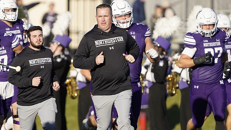 Nov 26, 2022; Evanston, Illinois, USA; Northwestern Wildcats head coach Pat Fitzgerald leads his team on the field against the Illinois Fighting Illini at Ryan Field. Mandatory Credit: David Banks-USA TODAY Sports