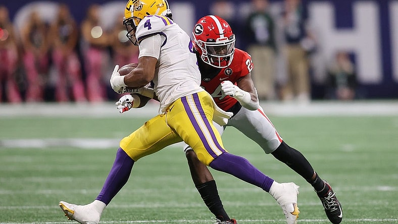Dec 3, 2022; Atlanta, GA, USA; LSU Tigers running back John Emery Jr. (4) is hit following his reception by Georgia Bulldogs defensive back Malaki Starks (24) during the second quarter at Mercedes-Benz Stadium. Mandatory Credit: Brett Davis-USA TODAY Sports