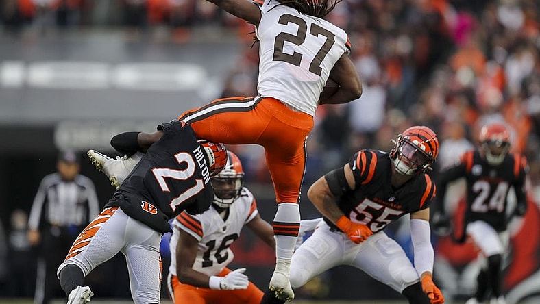 Dec 11, 2022; Cincinnati, Ohio, USA; Cincinnati Bengals cornerback Mike Hilton (21) brings down Cleveland Browns running back Kareem Hunt (27) in the second half at Paycor Stadium. Mandatory Credit: Katie Stratman-USA TODAY Sports