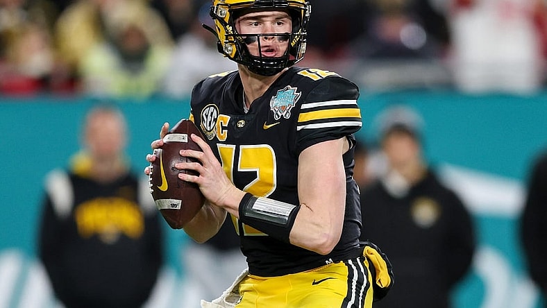Dec 23, 2022; Tampa, Florida, USA; Missouri Tigers quarterback Brady Cook (12) drops back to pass against the Wake Forest Demon Deacons in the first quarter in the 2022 Gasparilla Bowl at Raymond James Stadium. Mandatory Credit: Nathan Ray Seebeck-USA TODAY Sports