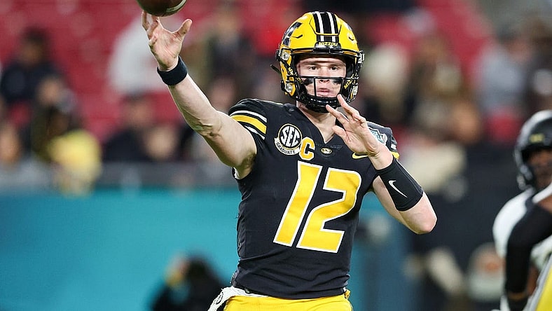 Dec 23, 2022; Tampa, Florida, USA; Missouri Tigers quarterback Brady Cook (12) throws a pass against the Wake Forest Demon Deacons during the first quarter in the 2022 Gasparilla Bowl at Raymond James Stadium. Mandatory Credit: Nathan Ray Seebeck-USA TODAY Sports