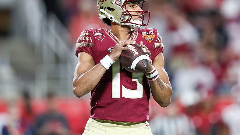 Dec 29, 2022; Orlando, Florida, USA; Florida State Seminoles quarterback Jordan Travis (13) drops back to pass against the Oklahoma Sooners in the second quarter during  the 2022 Cheez-It Bowl at Camping World Stadium. Mandatory Credit: Nathan Ray Seebeck-USA TODAY Sports