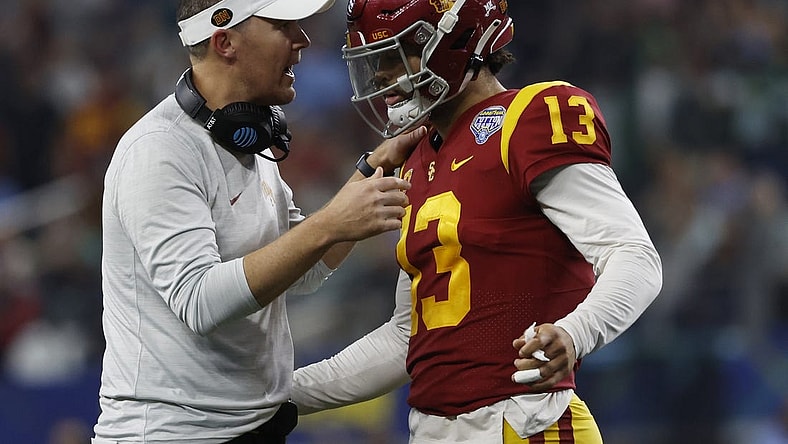 Jan 2, 2023; Arlington, Texas, USA; USC Trojans head coach Lincoln Riley talks to quarterback Caleb Williams (13) during the game against the Tulane Green Wave in the 2023 Cotton Bowl at AT&T Stadium. Mandatory Credit: Tim Heitman-USA TODAY Sports