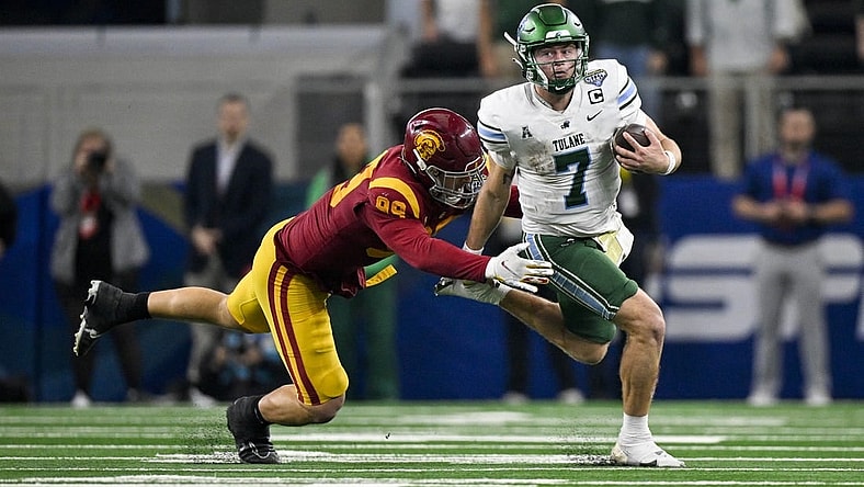 Jan 2, 2023; Arlington, Texas, USA; Tulane Green Wave quarterback Michael Pratt (7) and USC Trojans defensive lineman Nick Figueroa (99) in action during the game between the USC Trojans and the Tulane Green Wave in the 2023 Cotton Bowl at AT&T Stadium. Mandatory Credit: Jerome Miron-USA TODAY Sports