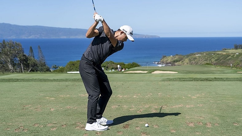 January 8, 2023; Maui, Hawaii, USA; Collin Morikawa hits his tee shot on the 11th hole during the final round of the Sentry Tournament of Champions golf tournament at Kapalua Resort - The Plantation Course. Mandatory Credit: Kyle Terada-USA TODAY Sports