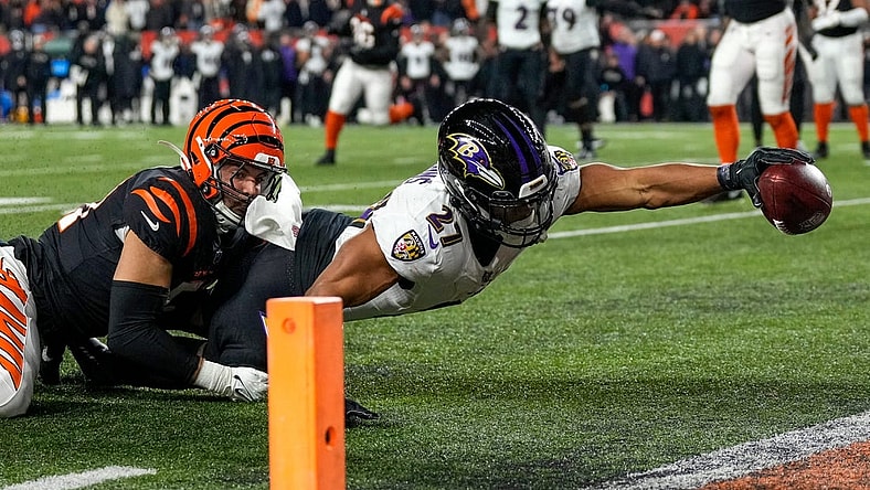 Baltimore Ravens running back J.K. Dobbins (27) breaks a tackle from Cincinnati Bengals linebacker Markus Bailey (51) stretches to break the plane for a touchdown in the second quarter during an NFL wild-card playoff football game between the Baltimore Ravens and the Cincinnati Bengals, Sunday, Jan. 15, 2023, at Paycor Stadium in Cincinnati.The Ravens led 10-9 at halftime.

Baltimore Ravens At Cincinnati Bengals Afc Wild Card Jan 15 124