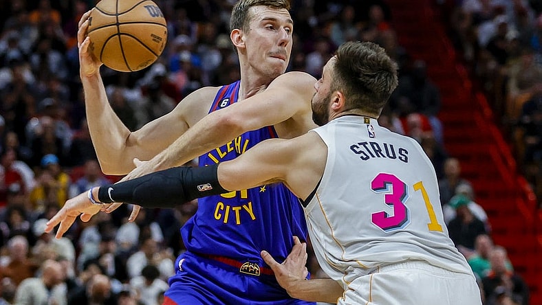 Feb 13, 2023; Miami, Florida, USA; Denver Nuggets forward Vlatko Cancar (31) protects the basketball from Miami Heat guard Max Strus (31) during the third quarter at Miami-Dade Arena. Mandatory Credit: Sam Navarro-USA TODAY Sports